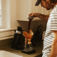 Pouring grounds into a Chemex 