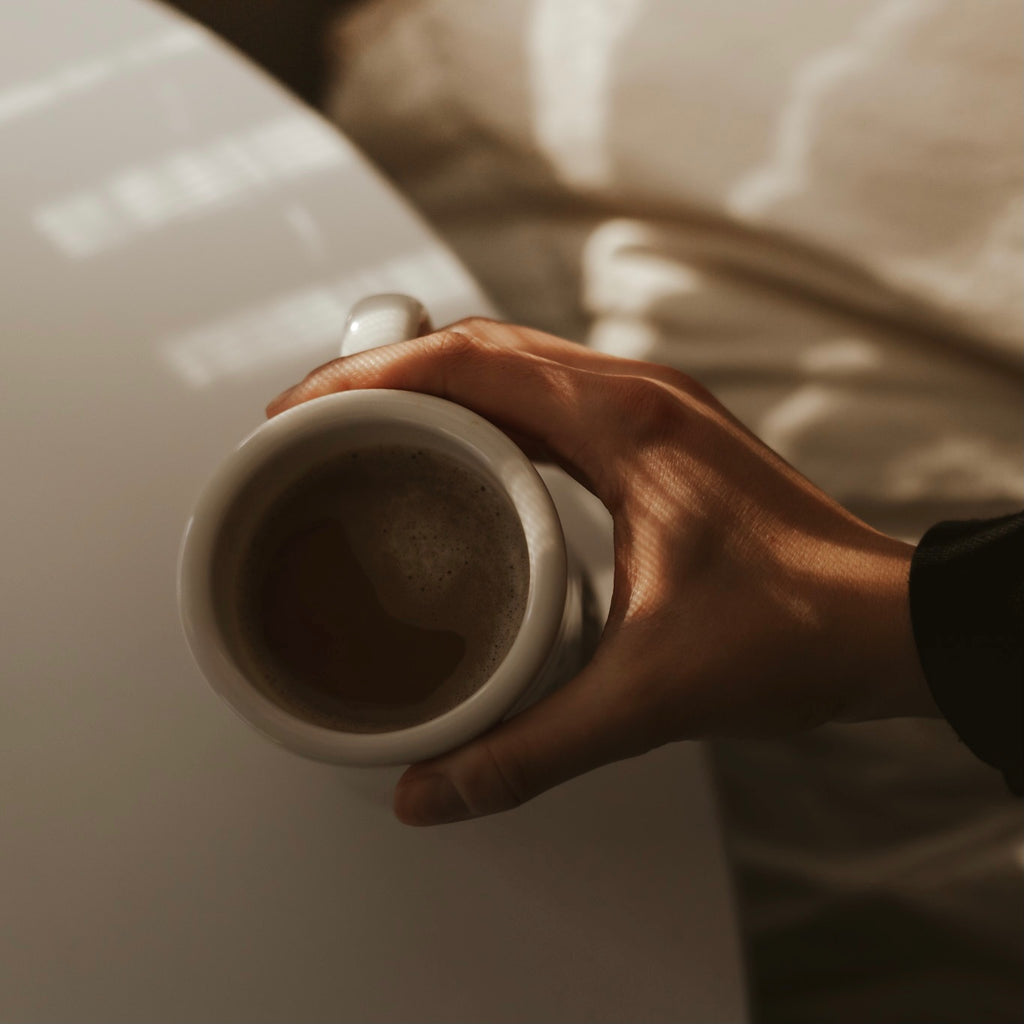 Hand holding a coffee mug 